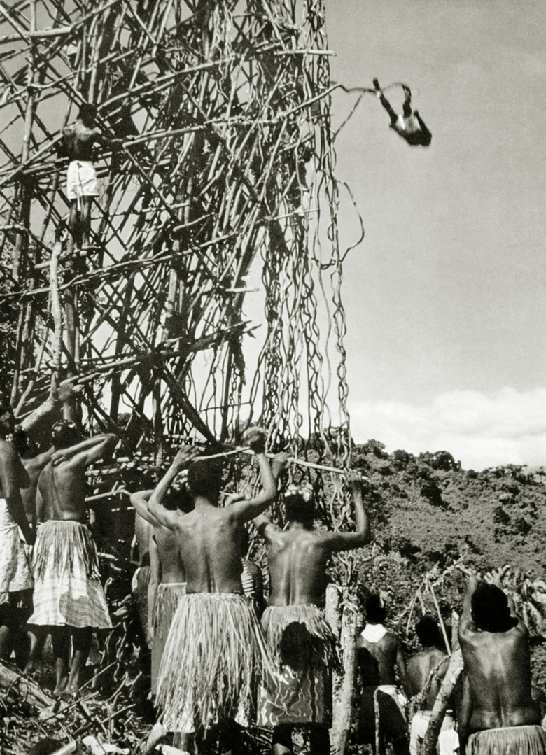 Diver jumping from a tower erected for Naghol (land diving) on Pentecost Island, Vanuatu, c.1920 / Private Collection / Prismatic Pictures / Bridgeman Images