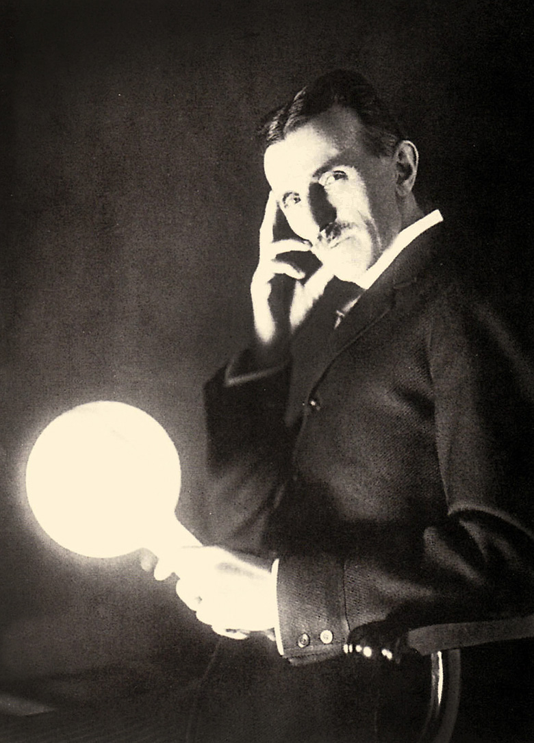 Portrait of Nikola Tesla holding a light bulb illuminated by the electromagnetic field of a Tesla Coil, 1899 (photo) / Private Collection / Prismatic Pictures / Bridgeman Images