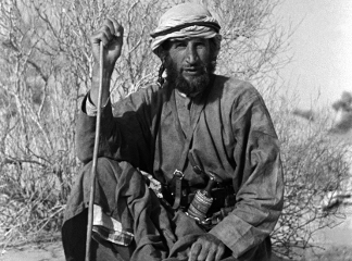 Portrait of Wilfred Thesiger sitting in the Wadi al ‘Ayn, Oman, February 8–16, 1949 (b/w photo), Salim Bin Kabina, (20th century) / Pitt Rivers Museum, Oxford, UK