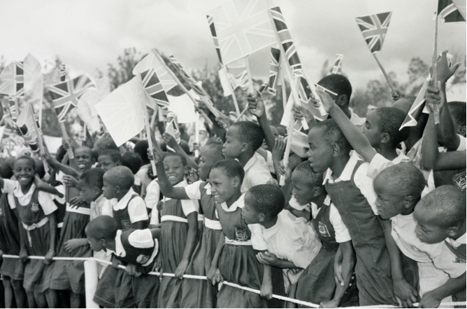 Schoolchildren waving flags for the visit of the Queen Mother, Eldoret, Kenya, 14th February 1959 (b/w photo), Charles Trotter (fl.c.1950s) © British Empire and Commonwealth Museum, UK