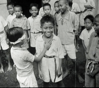 Indonesian children playing 'Blind Man's Bluff' at the opening of their new school, 1945 / Netherlands Institute for Sound and Vision / Bridgeman